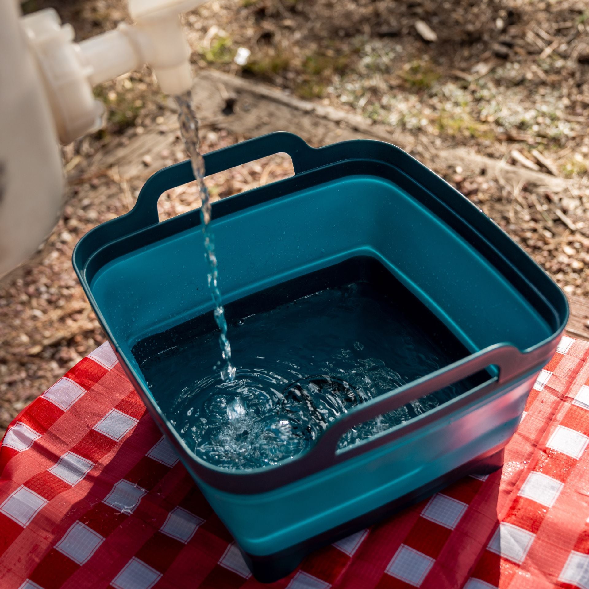 Collapsible Sink being filled from a water bottle