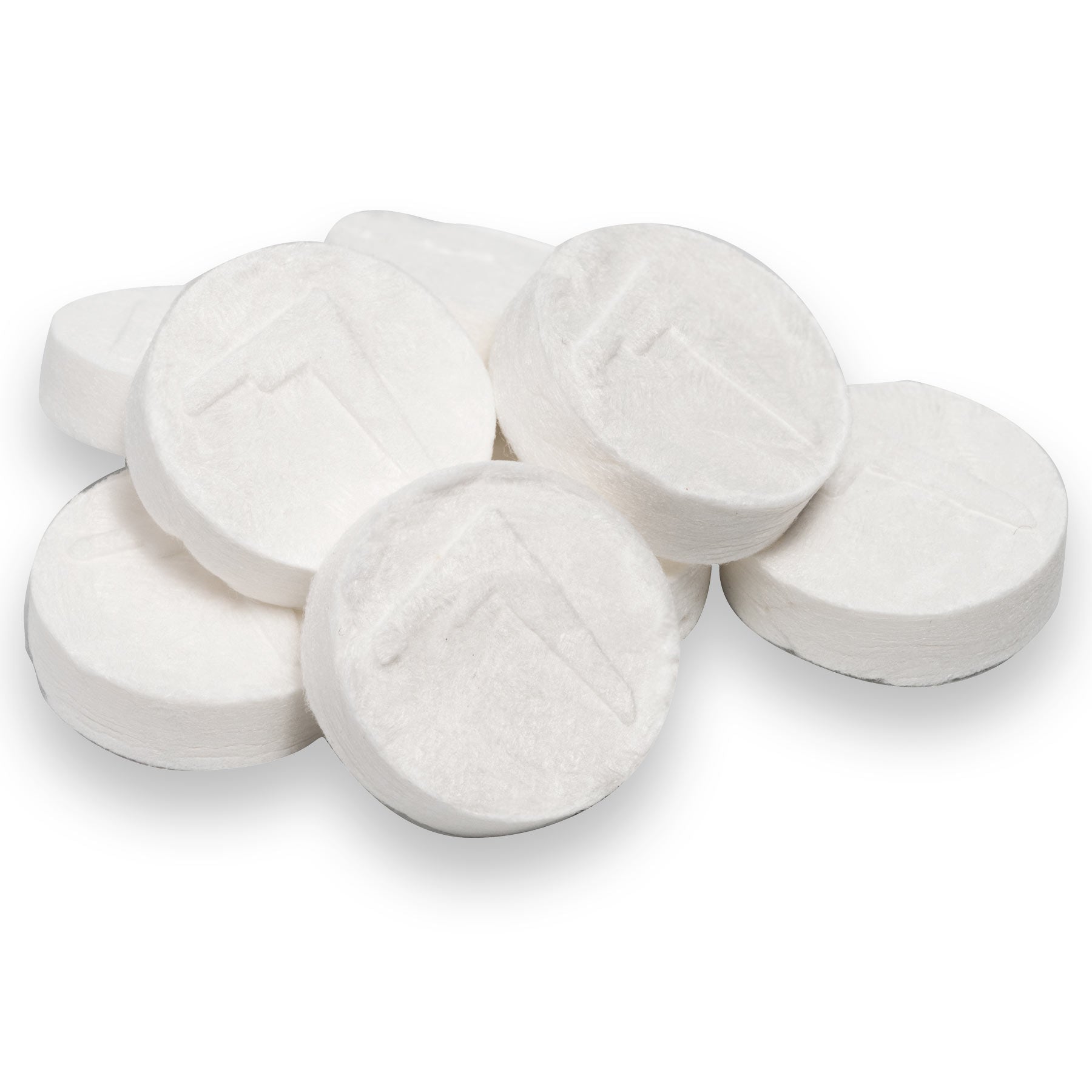 Seven Adventure Ready Compressed Towels in dry and compact puck form in a pile on white background.