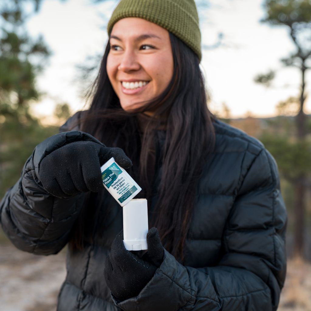 Woman uncapping Face the Frost